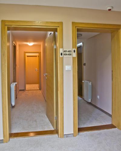 an empty hallway with two doors and a room with a hallway at Hotel Polar Star in Žabljak