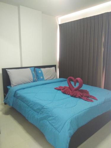a bed with two pink hearts on top of it at Grandbeach2 B52 By malai in Mae Pim