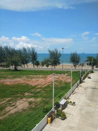 a view of a park with the ocean in the background at Grandbeach2 B52 By malai in Mae Pim