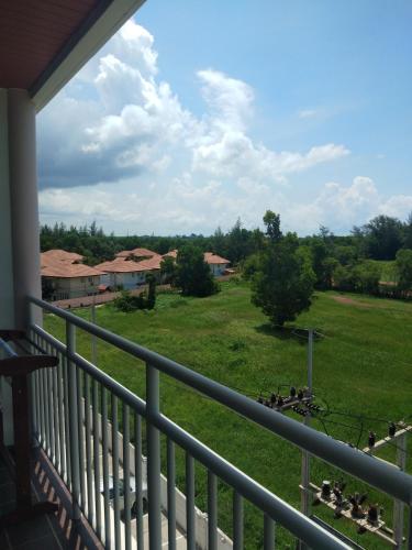 a balcony with a view of a yard with ducks at Grandbeach2 B52 By malai in Mae Pim
