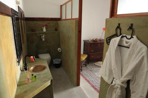 a bathroom with a sink and a toilet and a sink at Casa Colonial Koenig in São Filipe