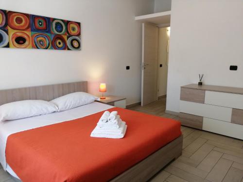 a bedroom with a bed with a red blanket at Appartamento in centro paese in Monterosi