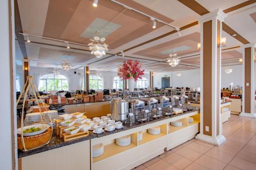 ein Restaurant mit einem Buffet mit Gerichten in der Unterkunft Grandvrio City Danang By Route Inn Group in Đà Nẵng