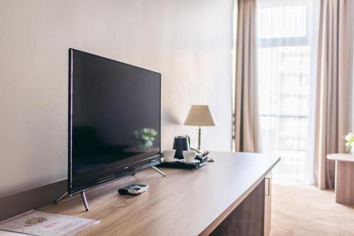 a large flat screen tv sitting on a desk at Hotel Forum in Rzeszów