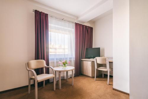 a room with a table and chairs and a window at Hotel Forum in Rzeszów