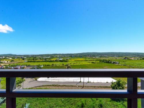 a view of a field from a balcony at Lisinty Resort in Hengchun