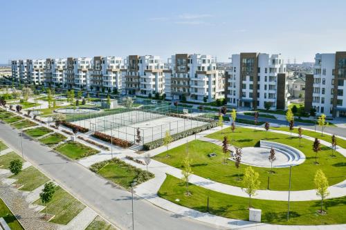 a park in a city with tall buildings at Dreamland Golf Hotel Baku in Baku