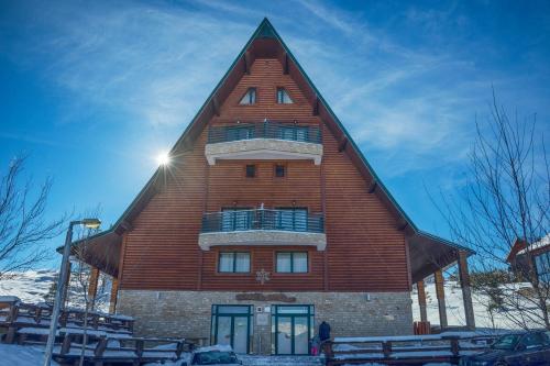 a large wooden building with a gambrel roof at Hotel Polar Star in Žabljak