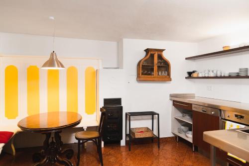 a kitchen with a table and yellow and white stripes at Apartments Golden Roof by Penz in Innsbruck