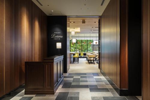 a lobby with a restaurant with a table at Hotel Monterey Le Frere Osaka in Osaka