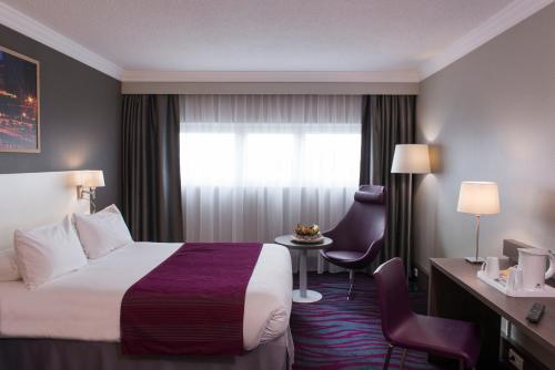 a hotel room with a bed and a window at Best Western Plus Paris Orly Airport in Rungis