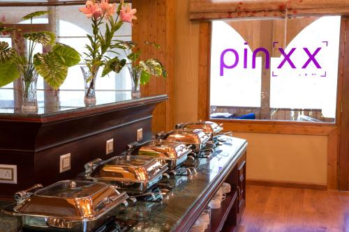a stove top oven with a bunch of pans on it at Regenta Inn by Riverside Manali in Manāli