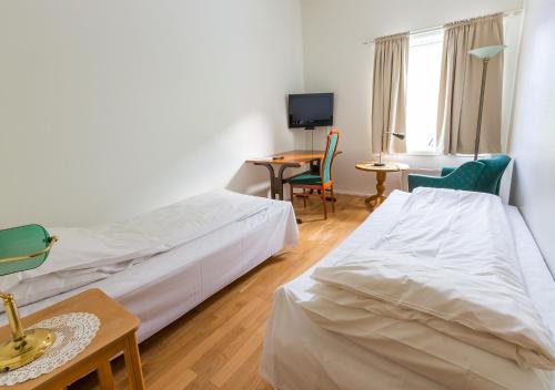 Ein Bett oder Betten in einem Zimmer der Unterkunft Strand Hotell Sortland