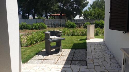 a bench sitting on the side of a yard at Villa del Sole in Manduria