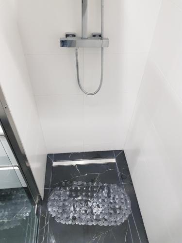a glass floor with a shower in a room at Central 2 in Craiova