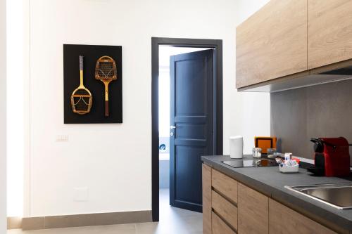 a kitchen with a blue door and a kitchen counter at Acate81 Lifestyle Apartment in Naples