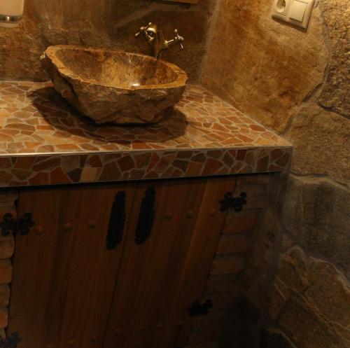 a bathroom with a stone sink on a counter at Apartmány Patriot in Třeboň