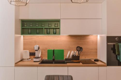 a kitchen with a counter with a sink and a stove at Urban Eden - LUX & STYLE, 2-Bedroom, 2-Bathroom in Sofia
