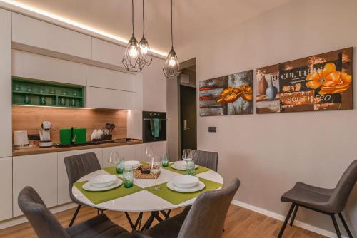 a kitchen and dining room with a table and chairs at Urban Eden - LUX & STYLE, 2-Bedroom, 2-Bathroom in Sofia