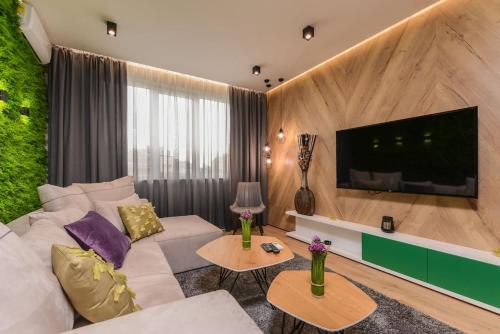 a living room with a white couch and a flat screen tv at Urban Eden - LUX & STYLE, 2-Bedroom, 2-Bathroom in Sofia