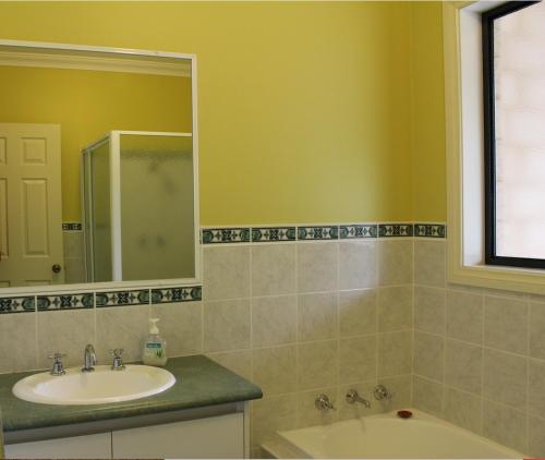 a bathroom with a sink and a mirror at Waterside View in Augusta