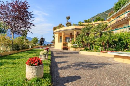 a building with flowers in front of it at Hotel San Pietro in Limone sul Garda