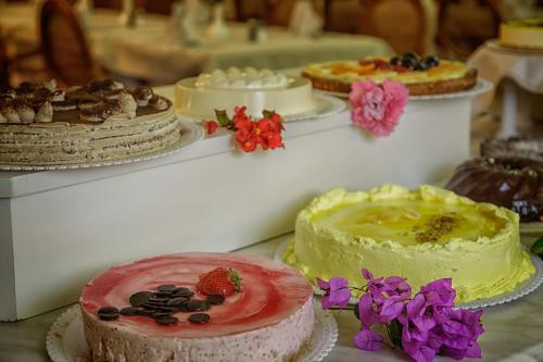 a table topped with cakes and other desserts on plates at Hotel San Pietro in Limone sul Garda