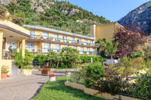 a hotel with a mountain in the background at Hotel San Pietro in Limone sul Garda