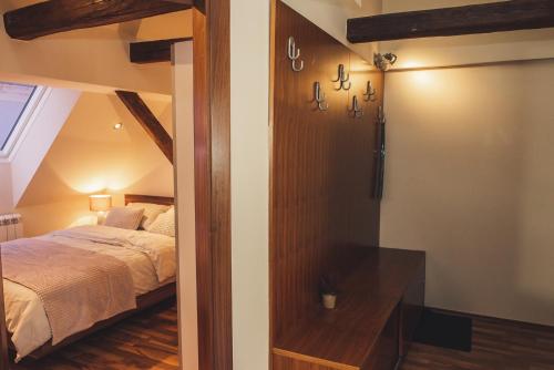 a bedroom with a bed and a door to a room at SKOL apartments in Celje