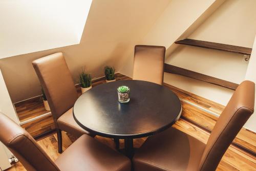 a small dining room with a table and chairs at SKOL apartments in Celje