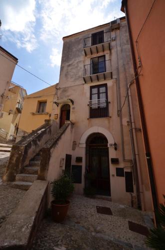 an old building with stairs leading up to it at Saraceni 20 in Cefalù