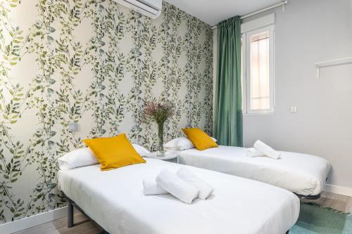 Ένα ή περισσότερα κρεβάτια σε δωμάτιο στο Waou Plaza de España II - Alquiler Corta Duración