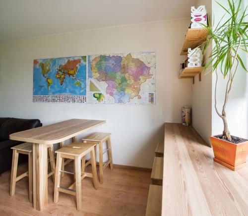 a table and chairs in a room with a map on the wall at Klaipeda Hostel in Klaipėda
