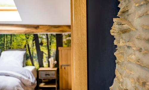 a view of a bedroom with a bed and a mirror at Pitch 15 in Nadrin