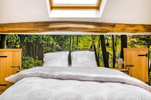 a bedroom with a bed and a window with trees at Pitch 15 in Nadrin
