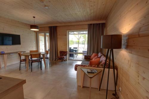 a living room with a couch and a table at Stranda in Giżycko