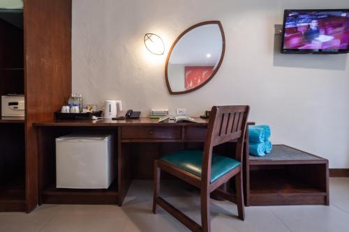 a desk with a mirror and a chair in a room at The Leaf Oceanside by Katathani - SHA Extra Plus in Khao Lak