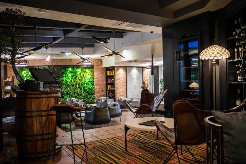 a lobby with a lot of chairs and a bar at Hotel Adamo in Tbilisi City