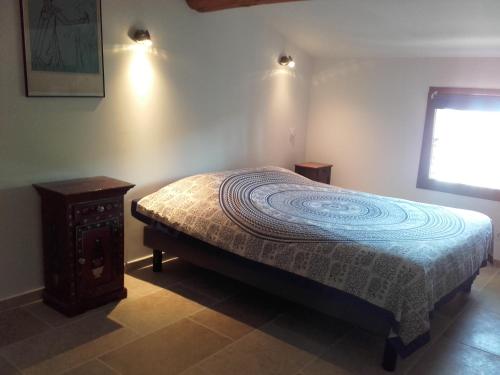 A bed or beds in a room at Appartement Domaine l'Oliveraie