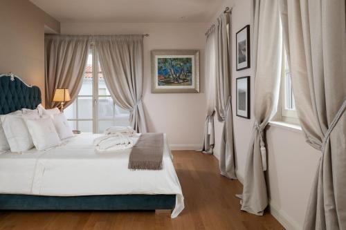 a bedroom with a white bed and a window at Villa Ivana in Vabriga
