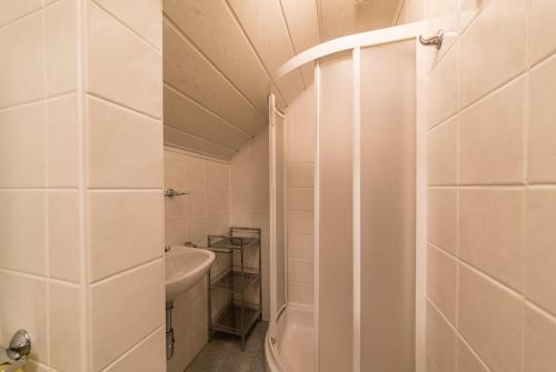 a white bathroom with a tub and a sink at Bauernhof Woltron in Würflach