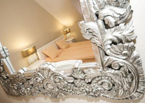 a bedroom with a bed with a large mirror at Kanclerz in Zamość