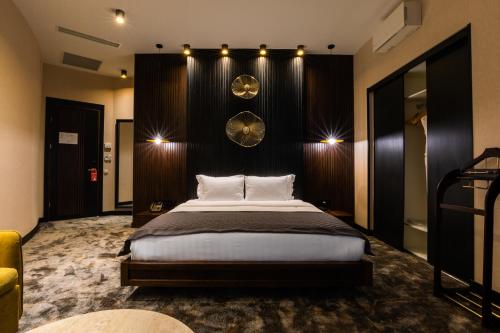a bedroom with a large bed in a room at Hotel Adamo in Tbilisi City