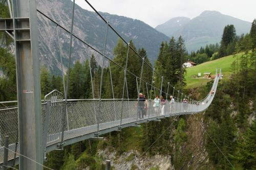 a group of people on a suspension bridge at Haus Gaby in Holzgau