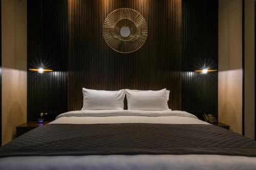 a bedroom with a large bed and a mirror at Hotel Adamo in Tbilisi City