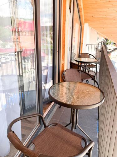 a row of tables and chairs on a balcony at Апартаменти "Золота Баня" in Skhidnitsa