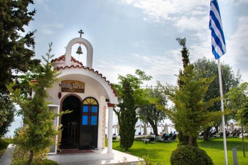 a small chapel with a flag in a park at Poseidon Palace in Leptokaria