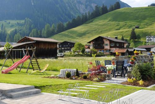 a yard with a playground with a slide at Haus Gaby in Holzgau