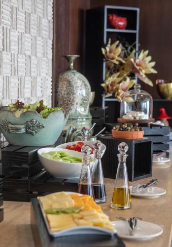 a table with a plate of food and a bowl of food at Hotel Adamo in Tbilisi City