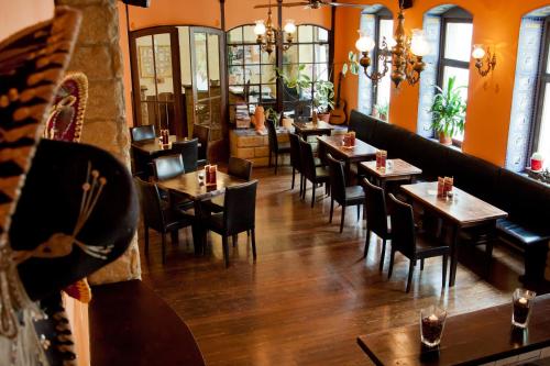 a restaurant with tables and chairs in a room at Gästehaus Mezcalero in Dresden